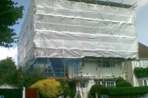 Scaffolding Covered with White Sheeting for Weather and Dust Protection
